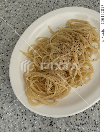 Creamy spaghetti carbonara made with rich egg yolk sauce, crispy bacon, parmesan cheese, and freshly ground black pepper for a classic, indulgent Italian pasta dish. 136122817