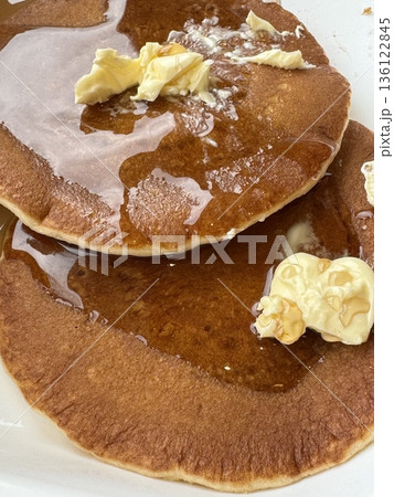 Fluffy and golden pancakes stacked high, served with syrup, butter, or fresh fruits. A warm and comforting breakfast classic that’s soft, sweet, and perfectly satisfying. 136122845