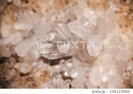 Natural quartz crystal cluster with transparent and milky hexagonal formations growing on a rocky matrix Natural quartz crystal cluster with transparent and milky hexagonal formations growing on a rocky matrix 136123000