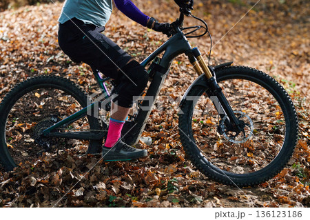 Autumn Mountain Biking Action On Leafy Trail With Front Suspension Bicycle And Vibrant Gear Autumn Mountain Biking Action On Leafy Trail With Front Suspension Bicycle And Vibrant Gear 136123186