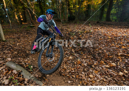 Autumn Forest Mountain Bike Rider Navigates Leaf-Litter Trail with Speed and Focus Autumn Forest Mountain Bike Rider Navigates Leaf-Litter Trail with Speed and Focus 136123191