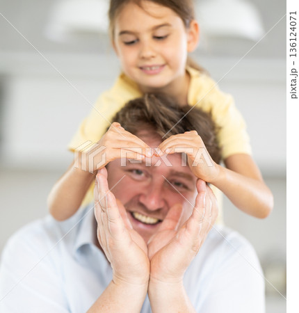 Father and little daughter posing in domestic interior 136124071