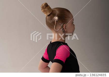 Child head with cochlear implant hearing aid. Copy space 136124835