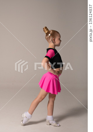 Portrait of child with cochlear implant during dance practice in studio. Hearing loss treatment, auditory rehabilitation, assistive medical device, emotional adaptation, and inclusive healthcare 136124837