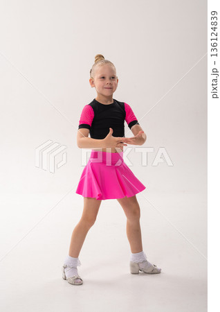 Young dancer with cochlear implant performing expressive sport dance movement. Hearing loss rehabilitation, auditory therapy, assistive technology, physical coordination, and confidence growth 136124839