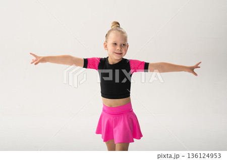 Portrait of child with cochlear implant during dance practice in studio. Hearing loss treatment, auditory rehabilitation, assistive medical device, emotional adaptation, and inclusive healthcare 136124953