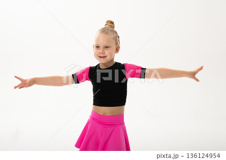 Young dancer with cochlear implant performing expressive sport dance movement. Hearing loss rehabilitation, auditory therapy, assistive technology, physical coordination, and confidence growth 136124954