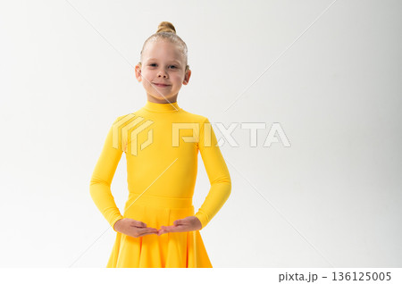 Close-up portrait of child with cochlear implant during dance practice. Copy space. Hearing loss treatment, auditory rehabilitation, assistive medical technology, emotional adaptation, and inclusive Close-up portrait of child with cochlear implant during dance practice. Copy space. Hearing loss treatment, auditory rehabilitation, assistive medical technology, emotional adaptation, and inclusive 136125005