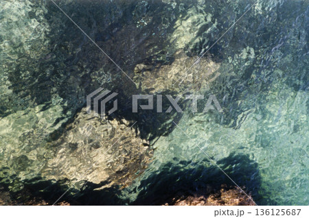 rocks on the seabed seen through transparent water rocks on the seabed seen through transparent water 136125687