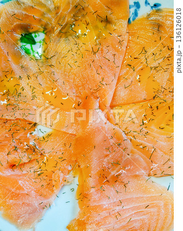 Smoked salmon slices with fresh dill and olive oil 136126018