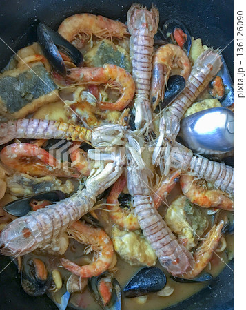 Fish zarzuela containing mussels, prawns, crayfish, hake and clams among other ingredients Fish zarzuela containing mussels, prawns, crayfish, hake and clams among other ingredients 136126090