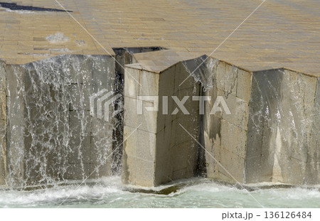 water feature formed by a large sloping surface lined with tile 136126484