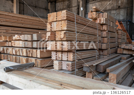 Stacked Wooden Beams and Planks in Warehouse Stacked Wooden Beams and Planks in Warehouse 136126517