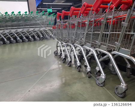 Rows of shopping carts lined up in a store during busy shopping hours Rows of shopping carts lined up in a store during busy shopping hours 136126694