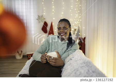 Woman enjoying festive Christmas season with hot drink Woman enjoying festive Christmas season with hot drink 136127192