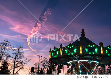 Illuminated Carousel at Dusk with Dramatic Sky 136127289
