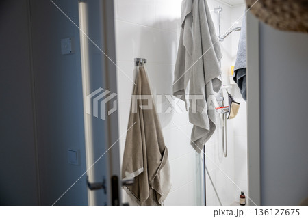 Minimal bathroom interior with towels hanging in modern shower 136127675