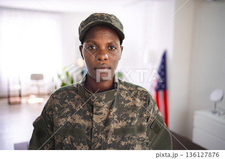 Portrait of a serious african american soldier standing indoors Portrait of a serious african american soldier standing indoors 136127876