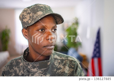 Confident african american female soldier wearing camouflage uniform indoors Confident african american female soldier wearing camouflage uniform indoors 136127885