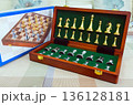 chessboard with golden and silver pieces isolated close-up 136128181