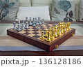 chessboard with golden and silver pieces isolated close-up 136128186