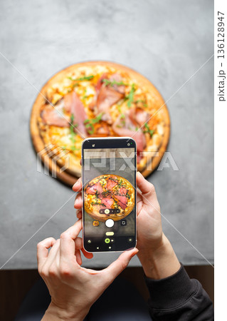Taking photo of italian pizza by smartphone Taking photo of italian pizza by smartphone 136128947