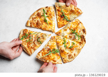 Hands taking slices of pizza 136129019