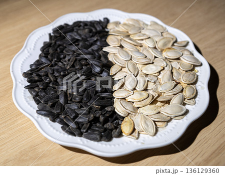Monochromatic food composition of various edible seeds on a dish. Monochromatic food composition of various edible seeds on a dish. 136129360