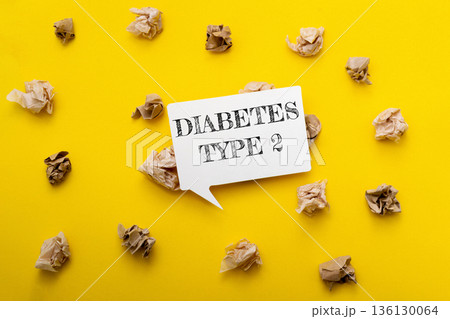 Diabetes type 2 awareness message on a vibrant yellow background with crumpled paper 136130064