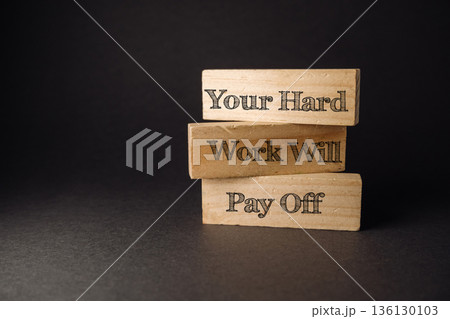 Inspirational wooden blocks with motivational phrase about hard work and success on dark background Inspirational wooden blocks with motivational phrase about hard work and success on dark background 136130103