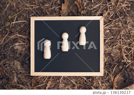 On the board there are three wooden figures rising up. 136130217