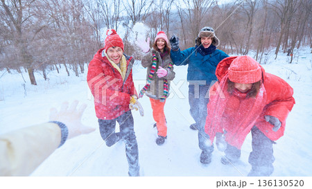 Friends running toward camera playing with snow in winter. 136130520