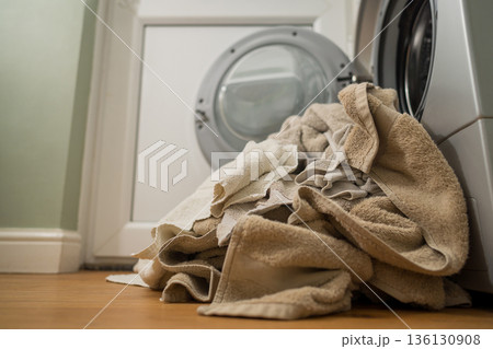 Washing machine with dirty towels on the floor near it. Laundry washer with opened door. Lifestyle. Copy space 136130908