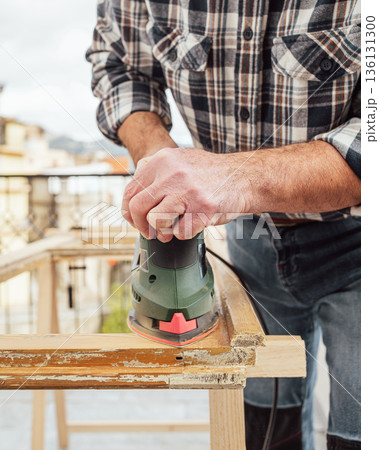 Carpenter at work, restoring an old wooden window. Carpentry. Carpenter at work, restoring an old wooden window. Carpentry. 136131300