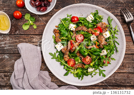 Warm beef meat salad with arugula Warm beef meat salad with arugula 136131732