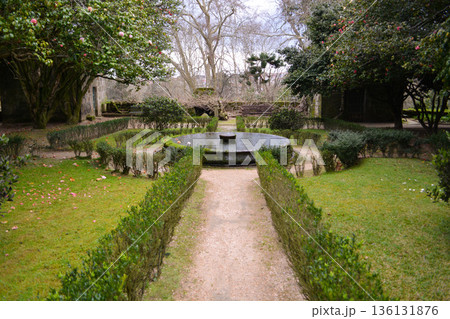A path in a park in Vigo, northern Italy, with mature trees and spreading branches. The concept encompasses tourism, tranquility, relaxation, sustainable development, and urban green spaces. A path in a park in Vigo, northern Italy, with mature trees and spreading branches. The concept encompasses tourism, tranquility, relaxation, sustainable development, and urban green spaces. 136131876