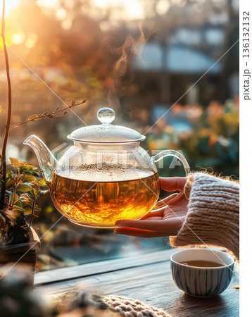 Person is holding a teapot with a lid on it Person is holding a teapot with a lid on it 136132132