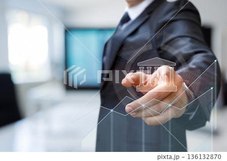 Businessman analyzes trends. 136132870