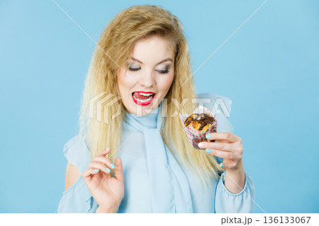 Attractive woman holds cake in hand 136133067
