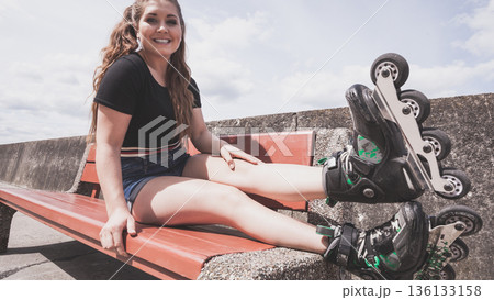 Young woman riding roller skates Young woman riding roller skates 136133158