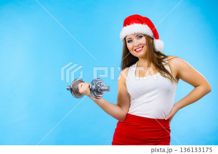 Santa claus woman lifting dumbbells Santa claus woman lifting dumbbells 136133175