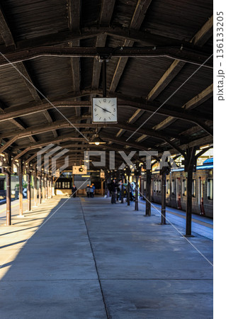 Clock at train station. A large clock faces public transport on a train platform.  136133205