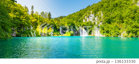 View of waterfall at Plitvice lakes, Croatia. Panoramic view of fresh nature, blue water and green trees. View of waterfall at Plitvice lakes, Croatia. Panoramic view of fresh nature, blue water and green trees. 136133330