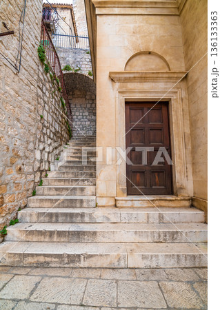 Narrow old town street at Sibenik city, Croatia. Famous tourist destination. 136133363