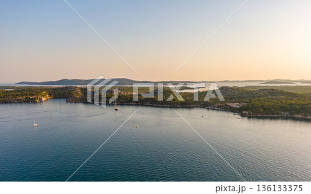 Aerial drone view of sunset over Kornati islands near the Sibenik city, Croatia. Water bay with boats ans soft sun light. Aerial drone view of sunset over Kornati islands near the Sibenik city, Croatia. Water bay with boats ans soft sun light. 136133375