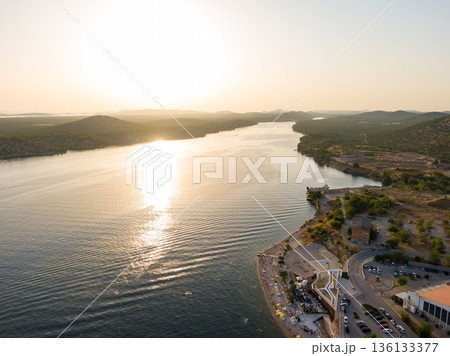 Aerial drone view of sunset over Kornati islands near the Sibenik city, Croatia. Water bay with boats ans soft sun light. 136133377