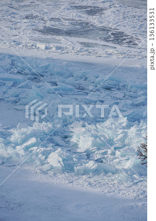 Layered turquoise ice shards and frozen plates form a textured winter surface on Lake Baikal under cold daylight 136133531