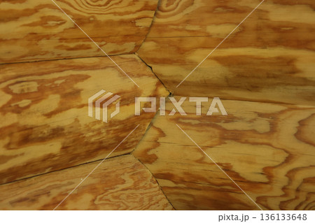 Fragment of a log cabin. Corner joint of the logs. View from inside the room. 136133648