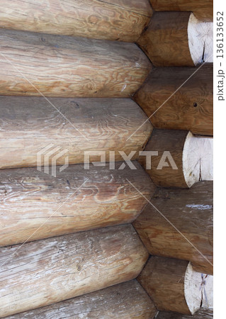 Fragment of a log cabin. New logs without bark. Fragment of a log cabin. New logs without bark. 136133652