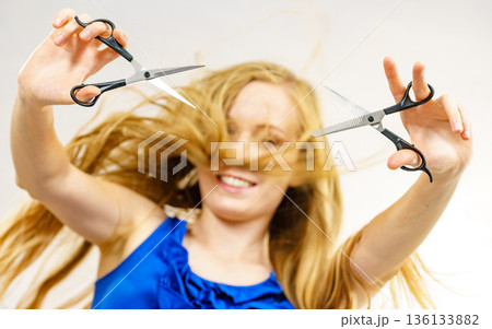 Girl with scissors for haircutting 136133882